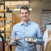 Image of Prof. Zac Hudson holding sustainable coffee pods
